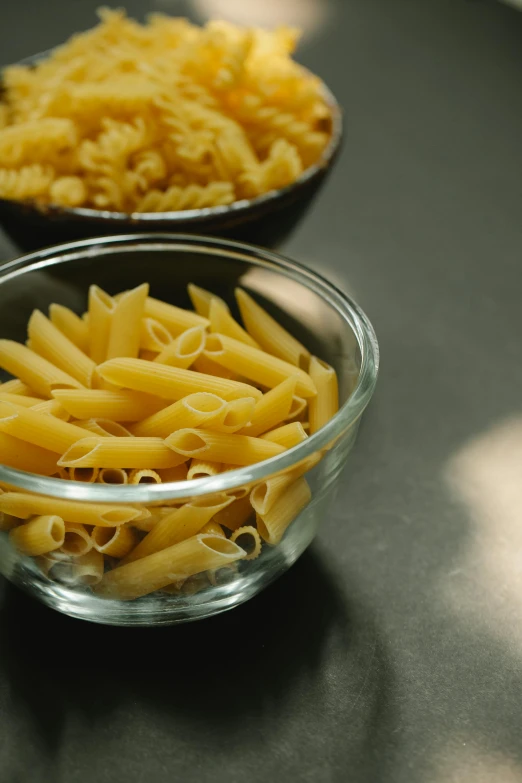 a couple of bowls filled with pasta on top of a table, ultraclear intricate, a close-up, pikes, high quality product image”