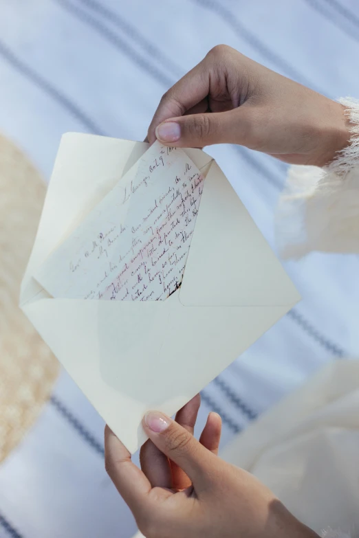 a close up of a person holding a piece of paper, letterism, greeting card, picnic, linen, romance