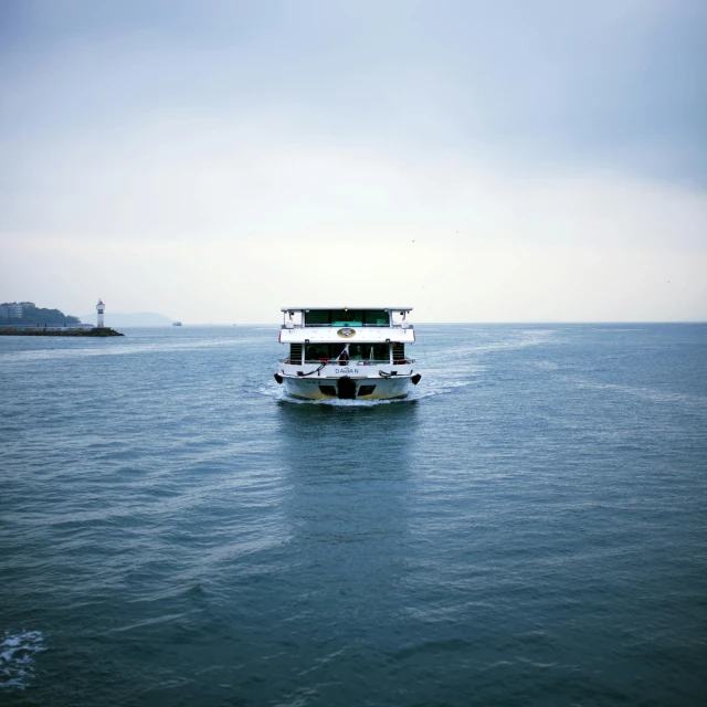 a boat in the middle of a body of water, an album cover, by Jang Seung-eop, unsplash, hurufiyya, hangzhou, green ocean, san francisco, shot on sony a 7