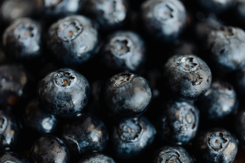 a pile of blueberries sitting on top of a wooden table, pexels, 🦩🪐🐞👩🏻🦳, avatar image, background image, close-up product photo