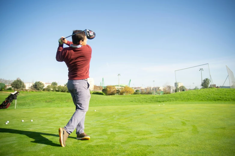 a man swinging a golf club at a golf course, a picture, shutterstock, happening, amr elshamy, avatar image, short dof, children's