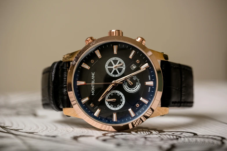 a close up of a watch on a table, pexels contest winner, gold and black blu, rose gold, three fourths view, thumbnail