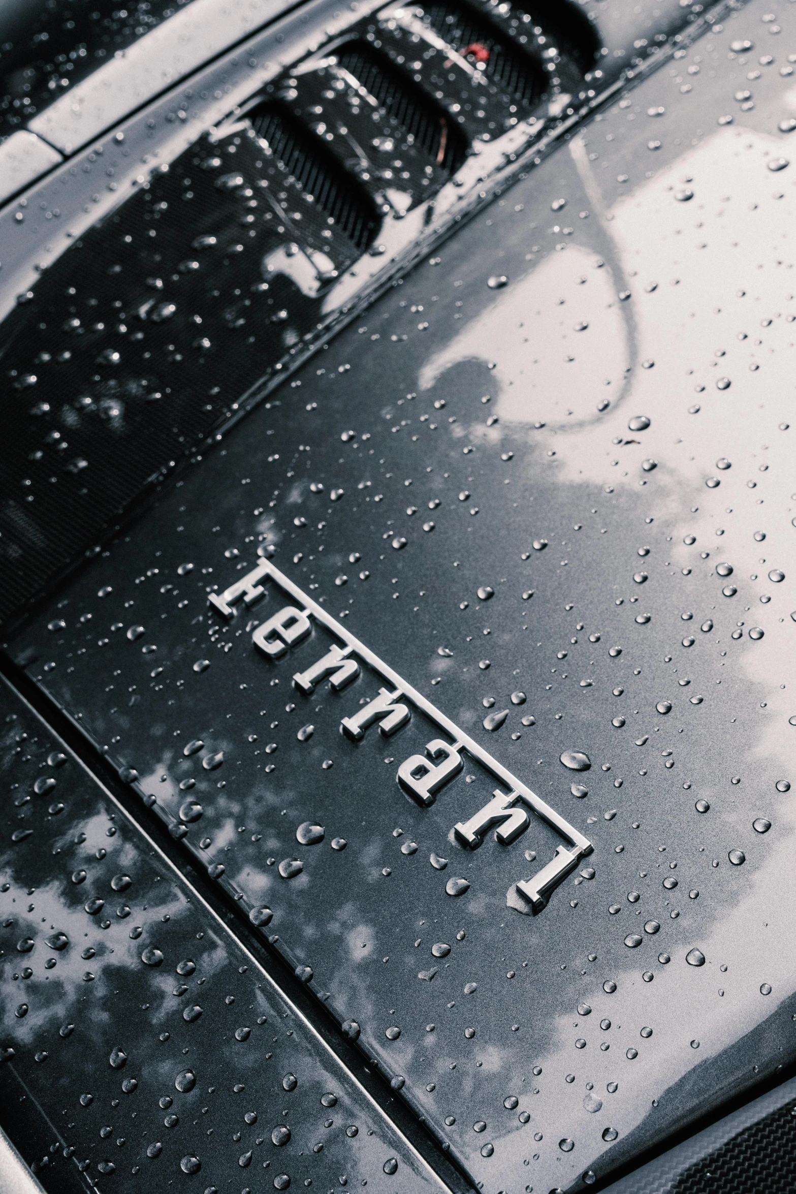 a close up of the hood of a car, an album cover, unsplash, hyperrealism, symbol for the word ersatz, showers, forza, spartan