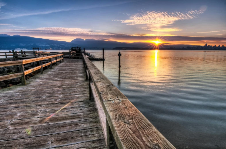 a wooden dock next to a body of water, pexels contest winner, sunset panorama, fan favorite, photo of zurich, seattle completely wasted away