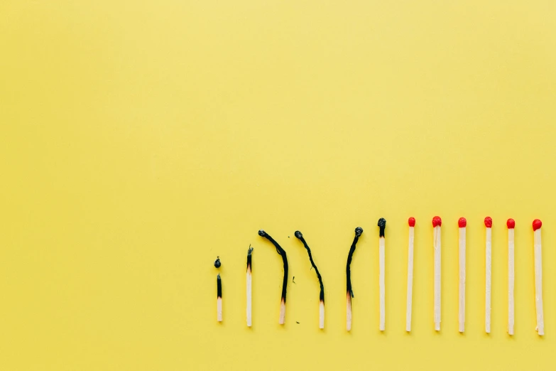 a row of matches on a yellow background, a picture, by Julia Pishtar, minimalism, brushes, we didn't start the fire, creativity, charts