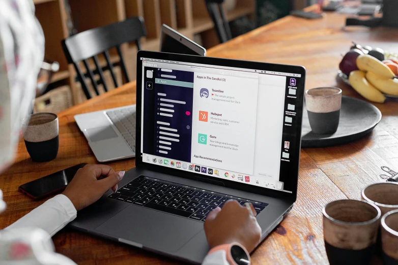 a person sitting at a table with a laptop, trending on unsplash, happening, purple, everything fits on the screen, 9 9 designs, angled shot