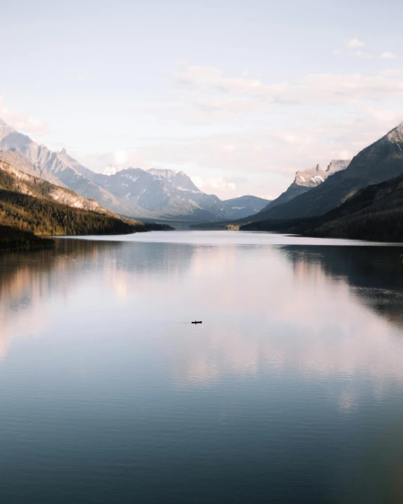 a body of water with mountains in the background, pexels contest winner, naturalism, small mouth, conde nast traveler photo, erin moriarty, grey