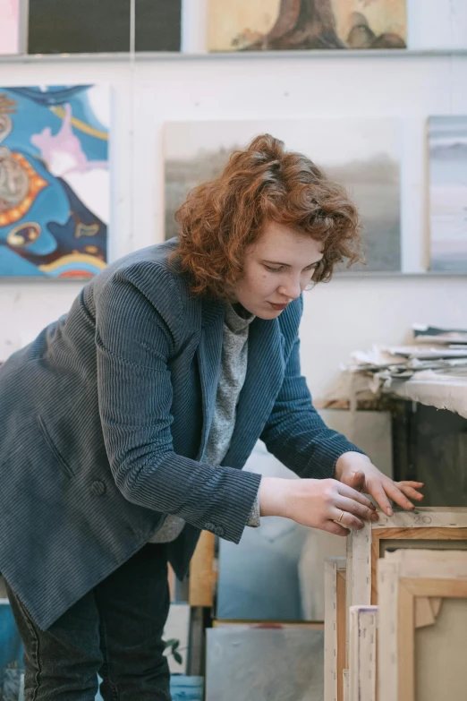 a woman working on a piece of art, by Helen Stevenson, arbeitsrat für kunst, a redheaded young woman, looking at the treasure box, ash thorp, rhys lee