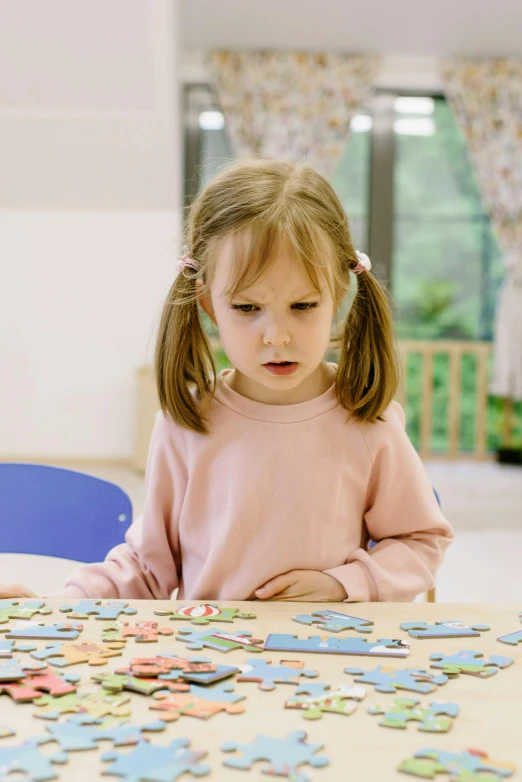 a little girl sitting at a table with a puzzle, 15081959 21121991 01012000 4k, full frame image, pastel', educational