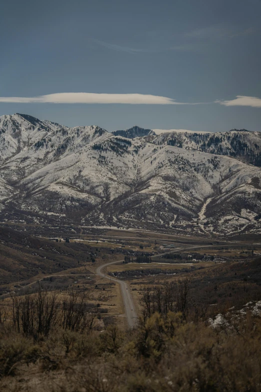 a mountain range with snow covered mountains in the distance, utah, tubes, shot with sony alpha, oc