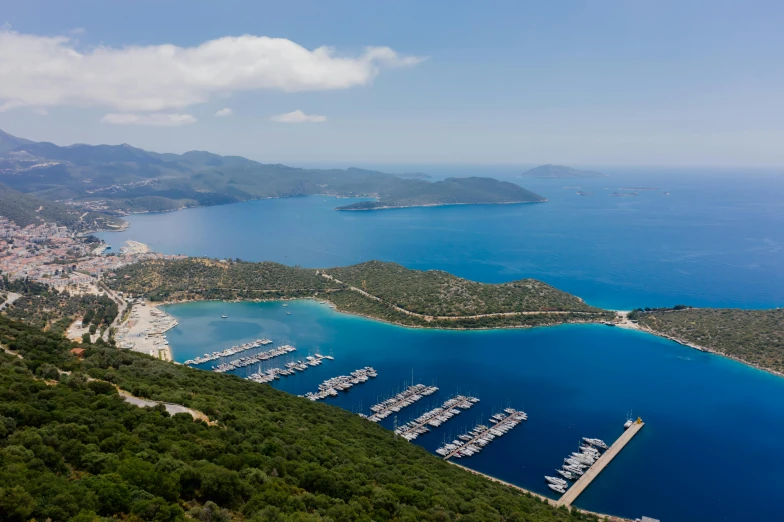 a large body of water next to a lush green hillside, by Julian Allen, pexels contest winner, hurufiyya, with water and boats, alexandros pyromallis, foster and partners, harbour