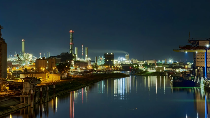 a large body of water next to a city at night, pexels contest winner, photorealism, chemical plant, warsaw, panoramic, glasgow