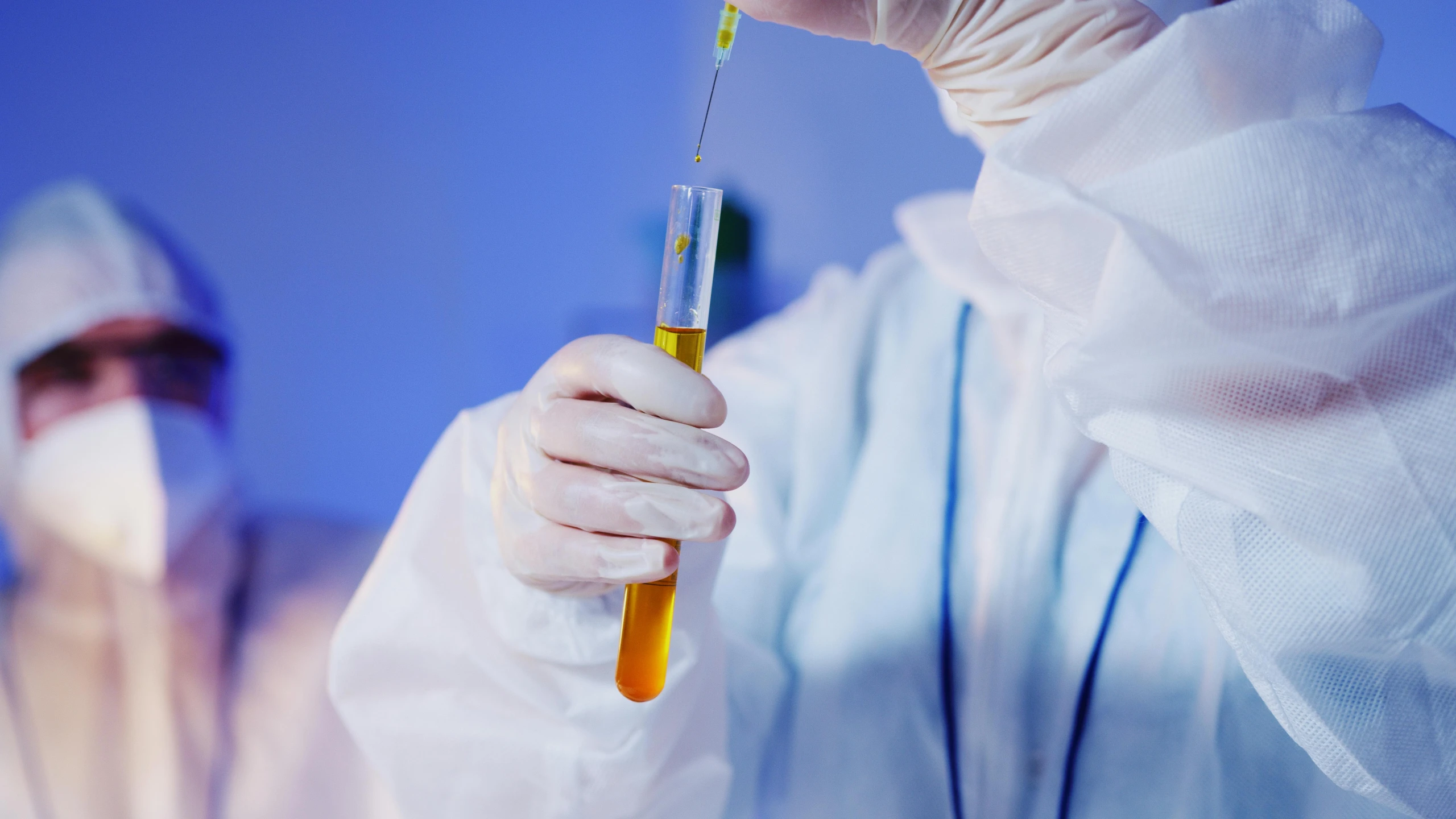 a person in a lab coat holding a test tube, coronavirus, steroid use, wearing a blue robe, iv pole