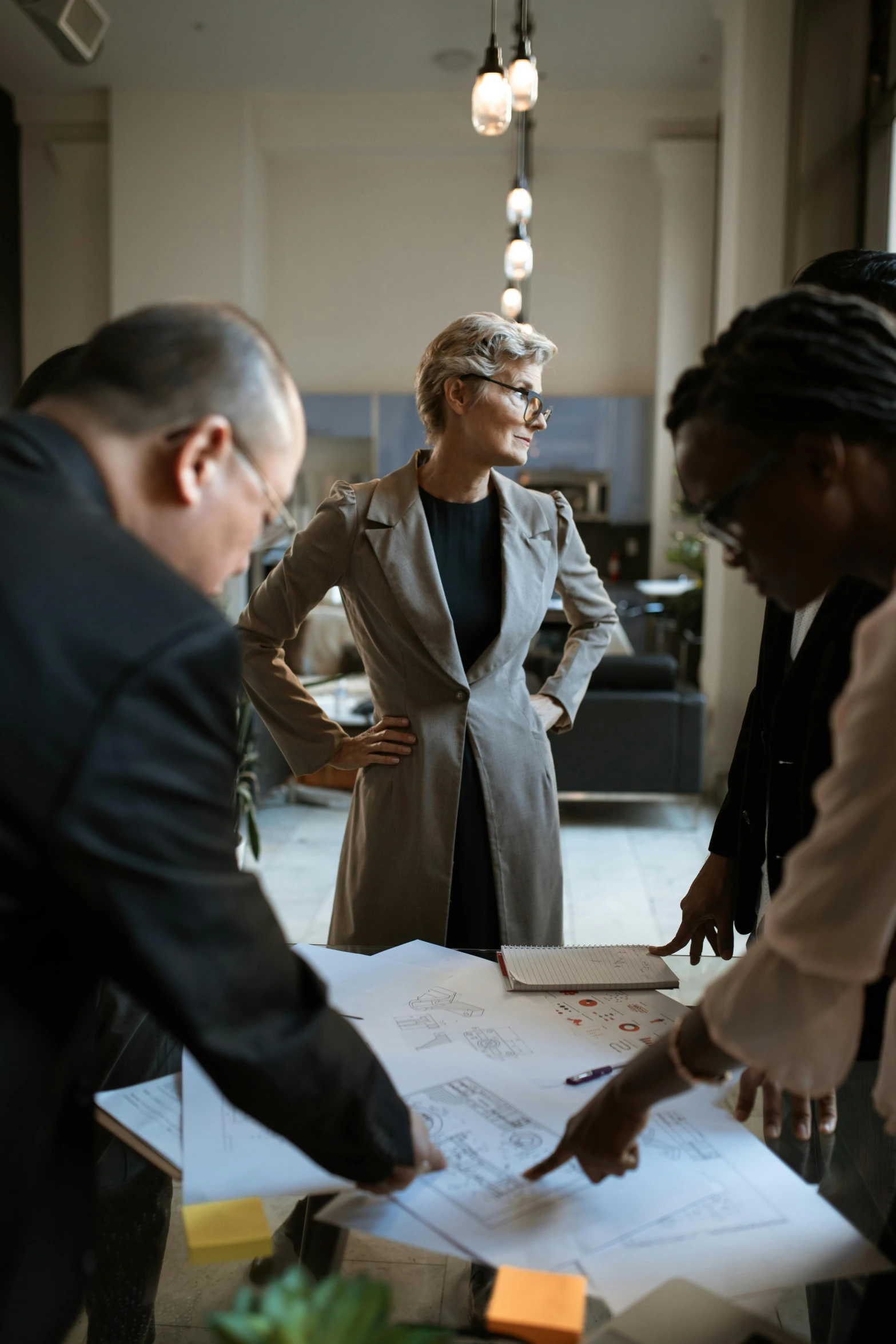 a group of people standing around a table, woman in business suit, top selection on unsplash, architectural planning, actors