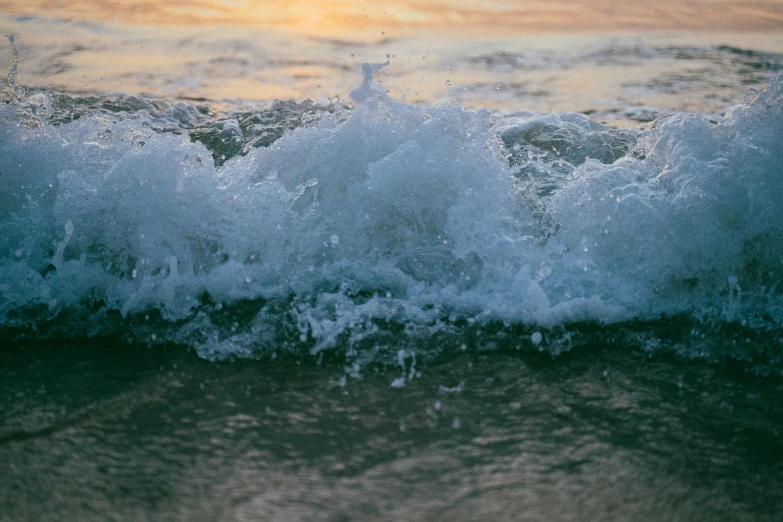 a person riding a surfboard on a wave in the ocean, an album cover, unsplash, renaissance, sea foam, early evening, washed up, zoomed in