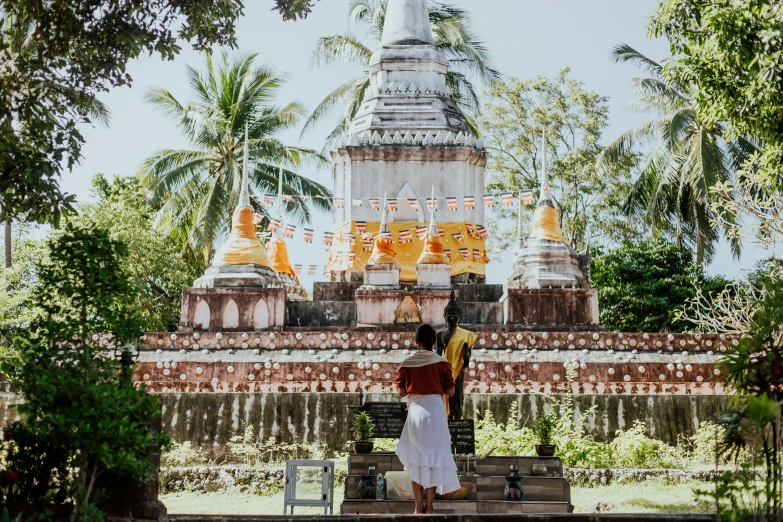 a woman standing in front of a building, thai temple, avatar image