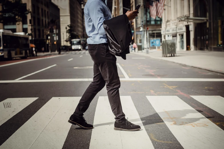 a man walking across a street holding an umbrella, pexels contest winner, happening, black denim pants, wearing business casual dress, new york streets, thumbnail