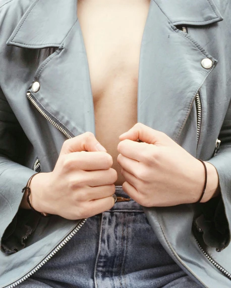 a close up of a person wearing a jacket, inspired by Ren Hang, trending on pexels, nipple, dressed in a gray, lgbt, bare midriff