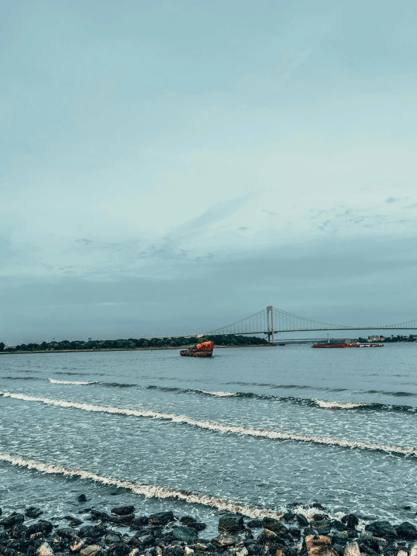 a body of water with a bridge in the background, by Daarken, pexels contest winner, happening, guwahati, interior of staten island ferry, beaching, today\'s featured photograph 4k