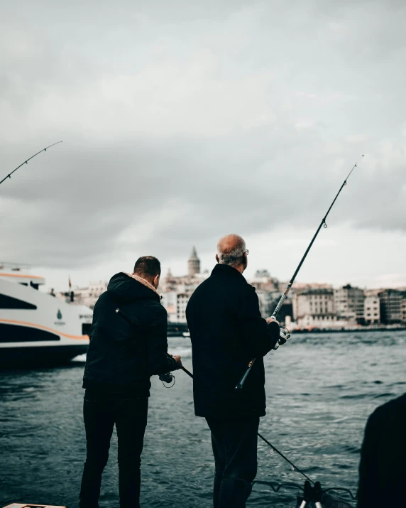 a couple of men standing on top of a boat, fishing pole, top selection on unsplash, grandfatherly, lgbt