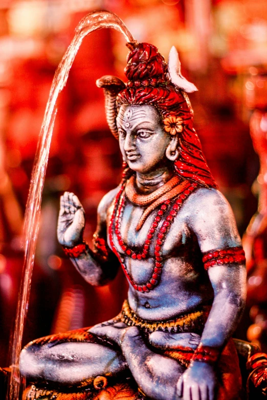 a statue of a man sitting in front of a fountain, pexels contest winner, samikshavad, red horns, avatar image, extremely detailed goddess shot, vibrant colours