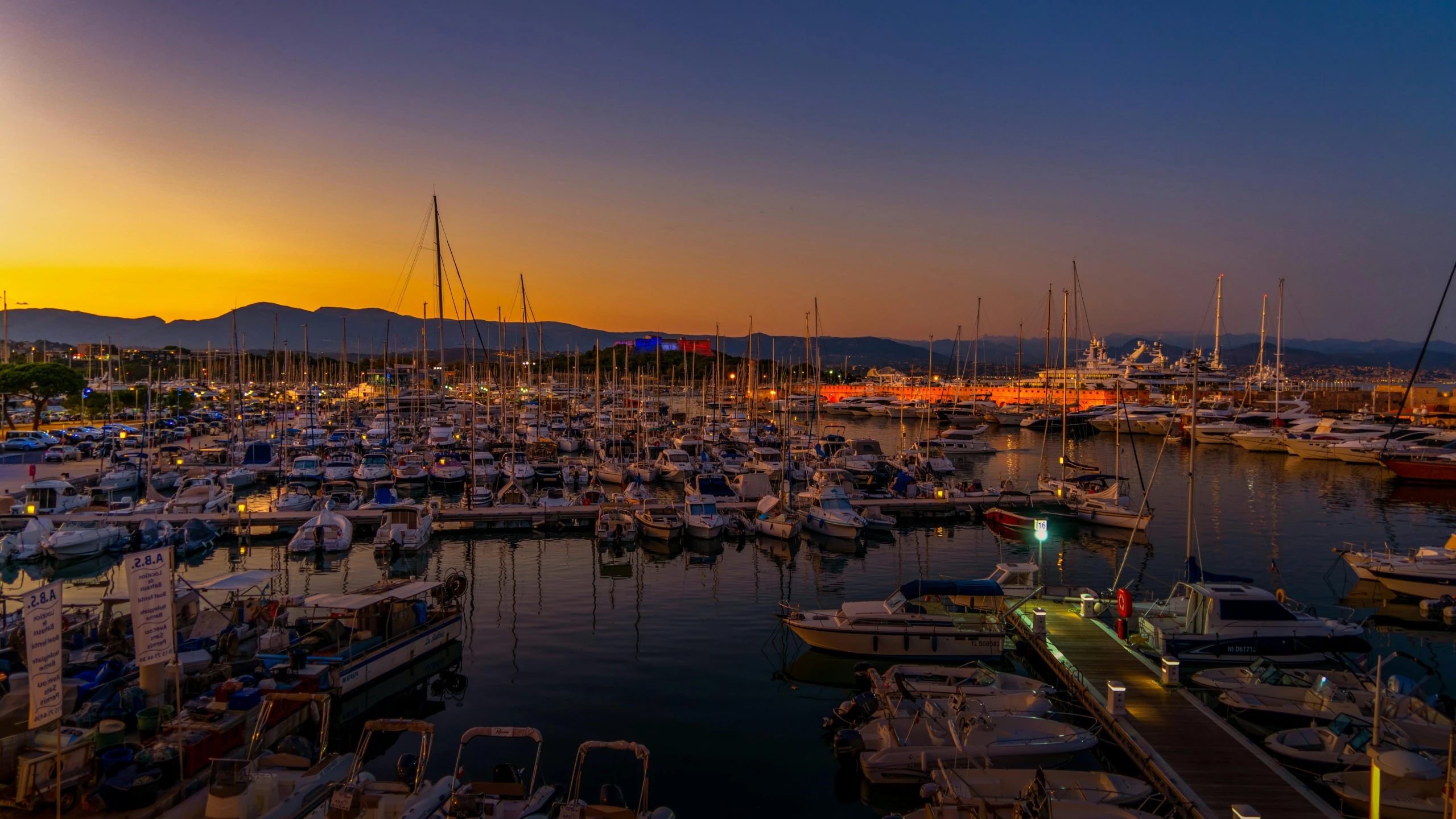 a marina filled with lots of boats at sunset, pexels contest winner, happening, night time photograph, cyprus, thumbnail, high quality image