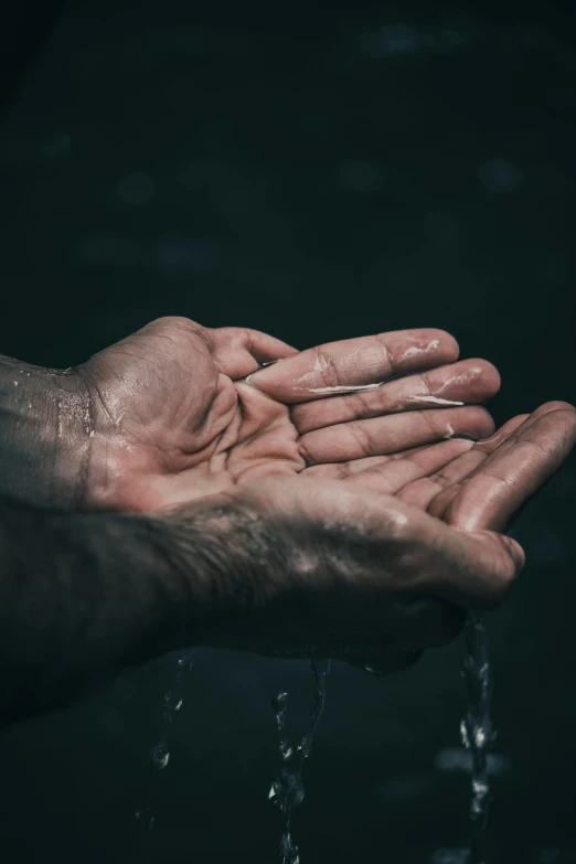 a person holding out their hands in the water, paul barson, hard rain, hydration, ultra textured