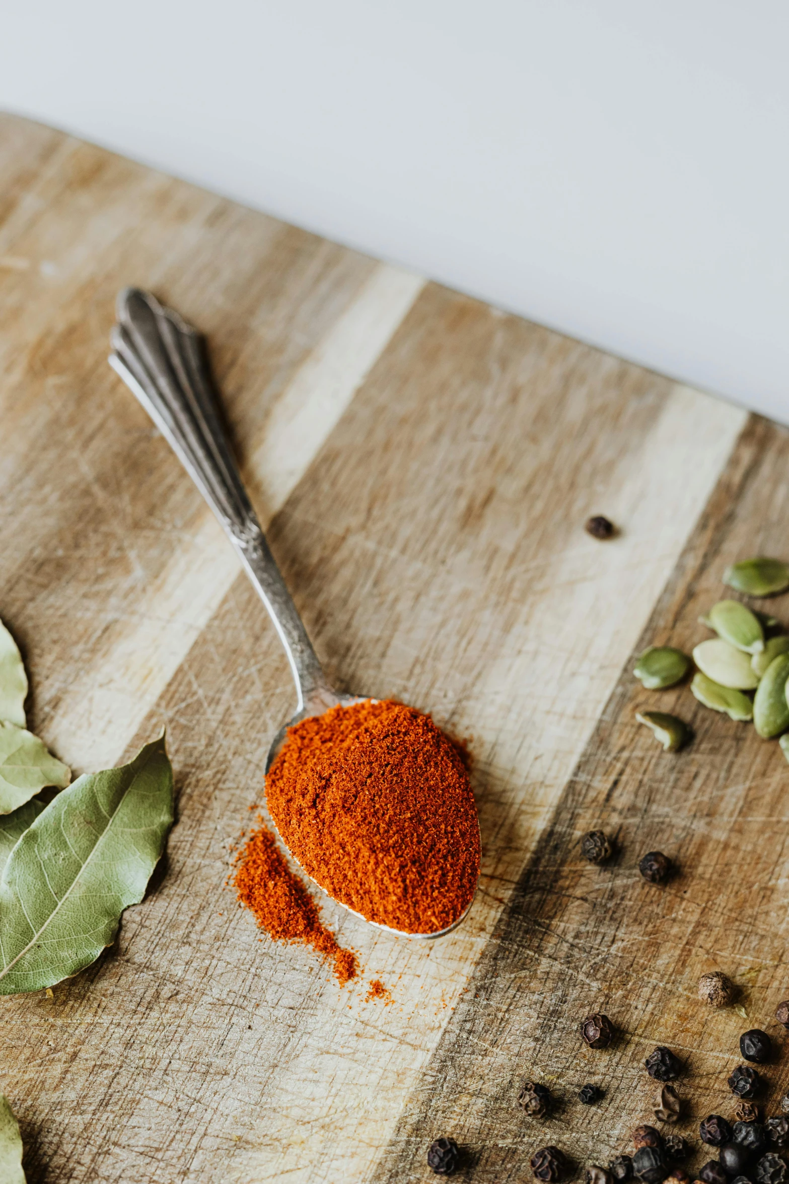 a wooden cutting board topped with spices and a spoon, by Jessie Algie, renaissance, paprika, magnesium, thumbnail, mint