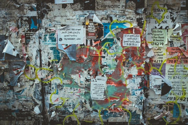 a wall covered in lots of different types of posters, a poster, inspired by Mimmo Rotella, pexels contest winner, graffiti, 144x144 canvas, postapocalyptic grunge, torn paper, billboard image