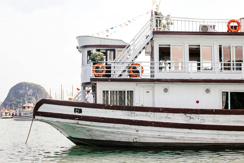 a large boat floating on top of a body of water, unsplash, private press, wedding, hoang long ly, saloon exterior, profile image