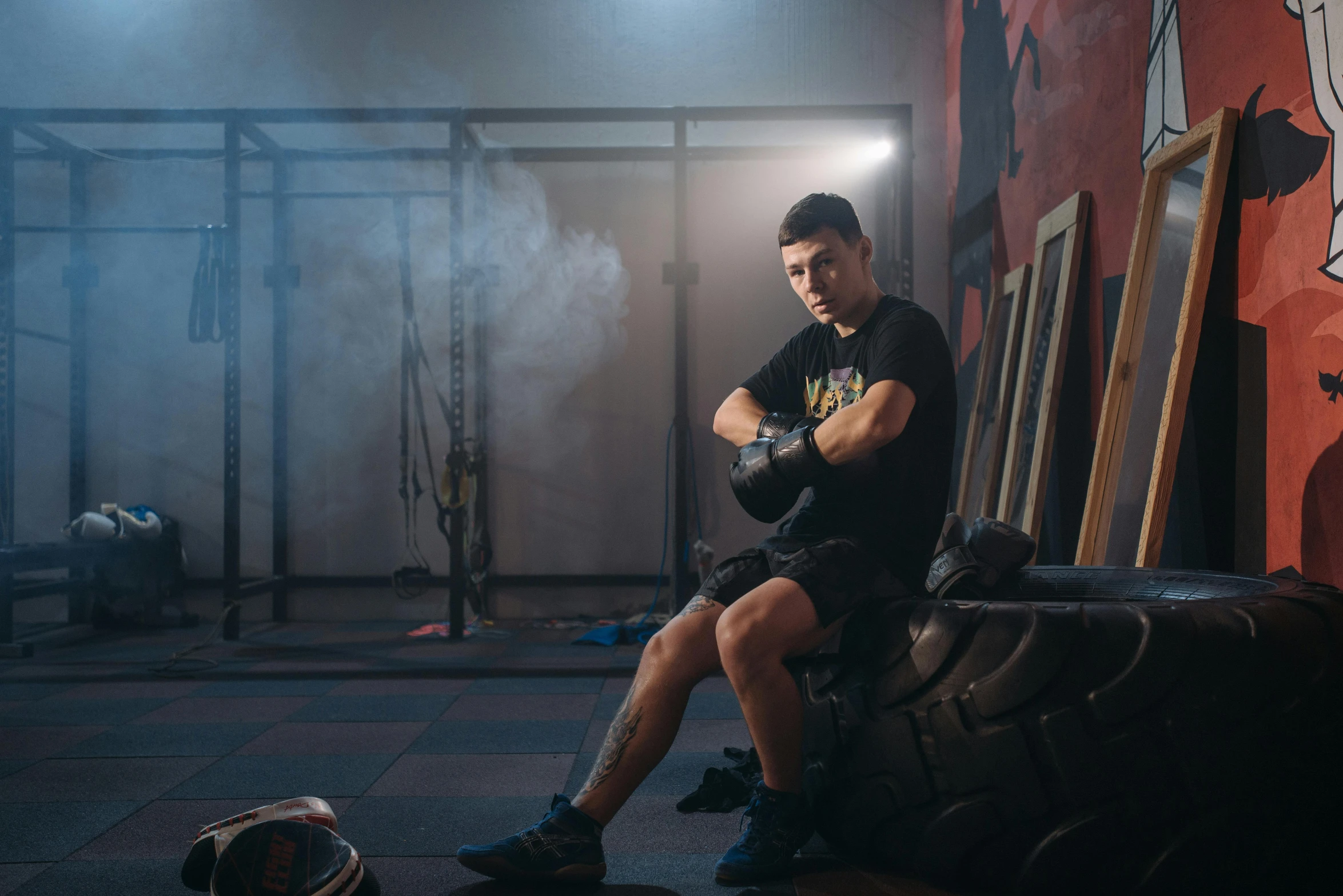 a man sitting on a couch in a gym, a portrait, by Adam Marczyński, pexels contest winner, demon boxing hero, athletic crossfit build, yulia nevskaya, profile image