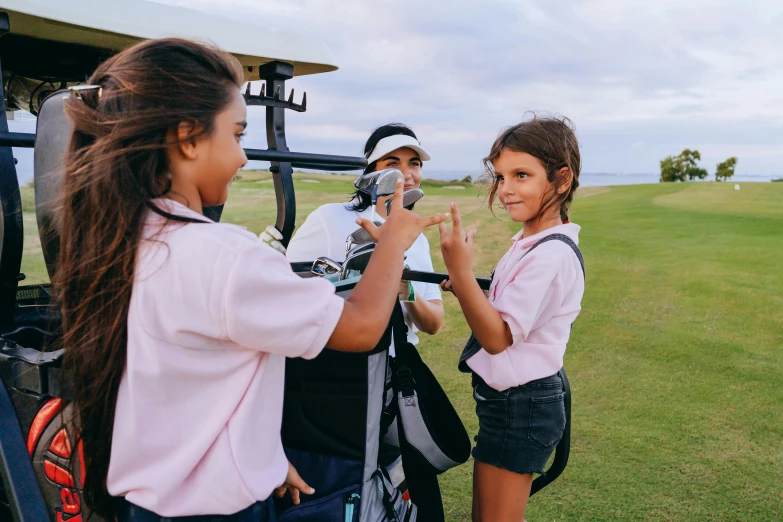 a couple of girls standing next to a golf cart, a picture, pexels contest winner, happening, avatar image, taking a picture, camilo gc, isabela moner