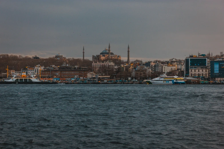 a large body of water with a city in the background, by Ismail Acar, pexels contest winner, hurufiyya, turkish and russian, slide show, grayish, port