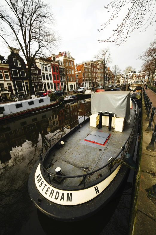 a boat that is sitting in the water, by Jan Tengnagel, happening, canals, in the center of the image, slide show, a cozy