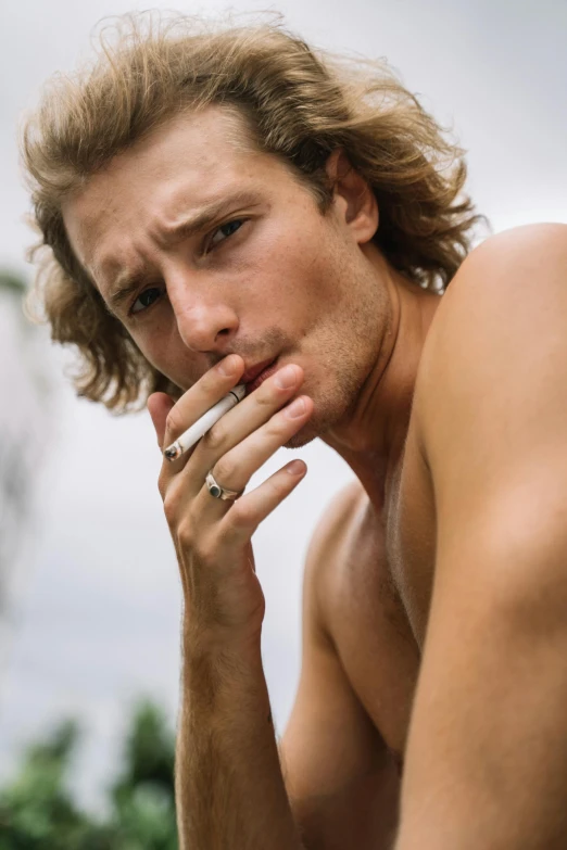 a shirtless young man smoking a cigarette, trending on pexels, ryan mcginley, square masculine jaw, bali, long boi