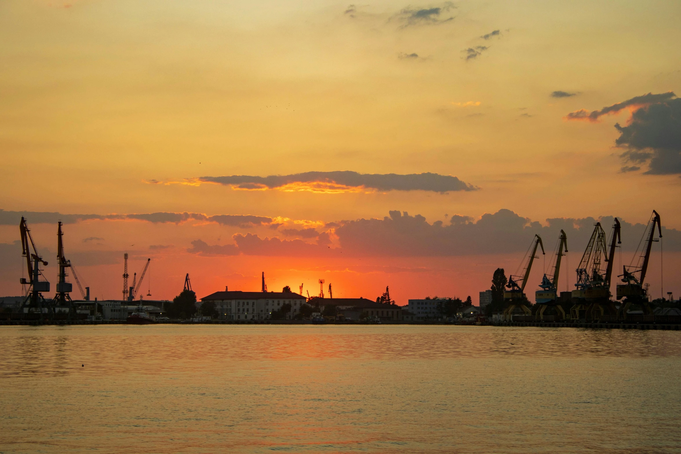 a large body of water with a sunset in the background, by Jan Tengnagel, pexels contest winner, shipyard, rostov city, where a large, panoramic