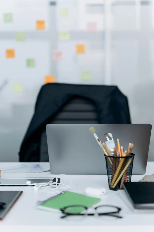 a laptop computer sitting on top of a white desk, whiteboards, thumbnail, blurred, multicoloured