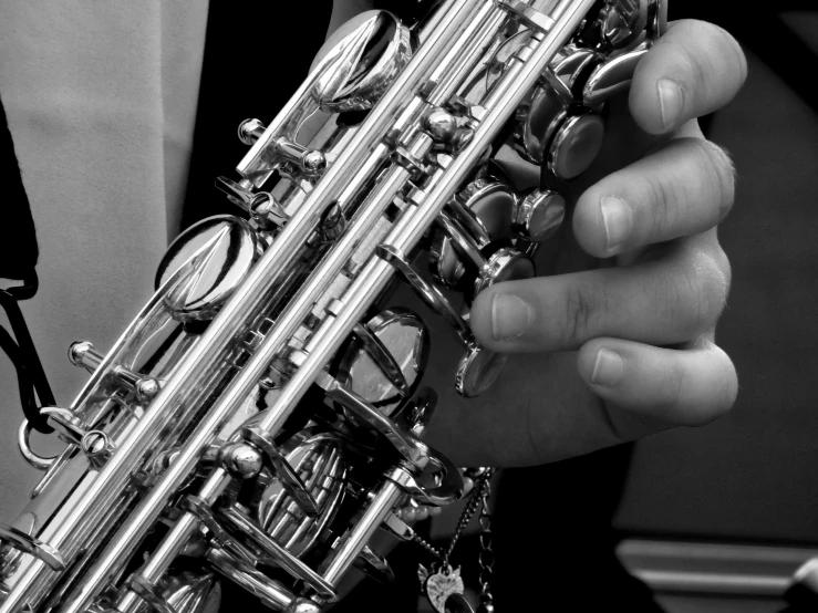 a close up of a person holding a saxophone, by Leonard Bahr, bw photo, 15081959 21121991 01012000 4k, exotic, silver details