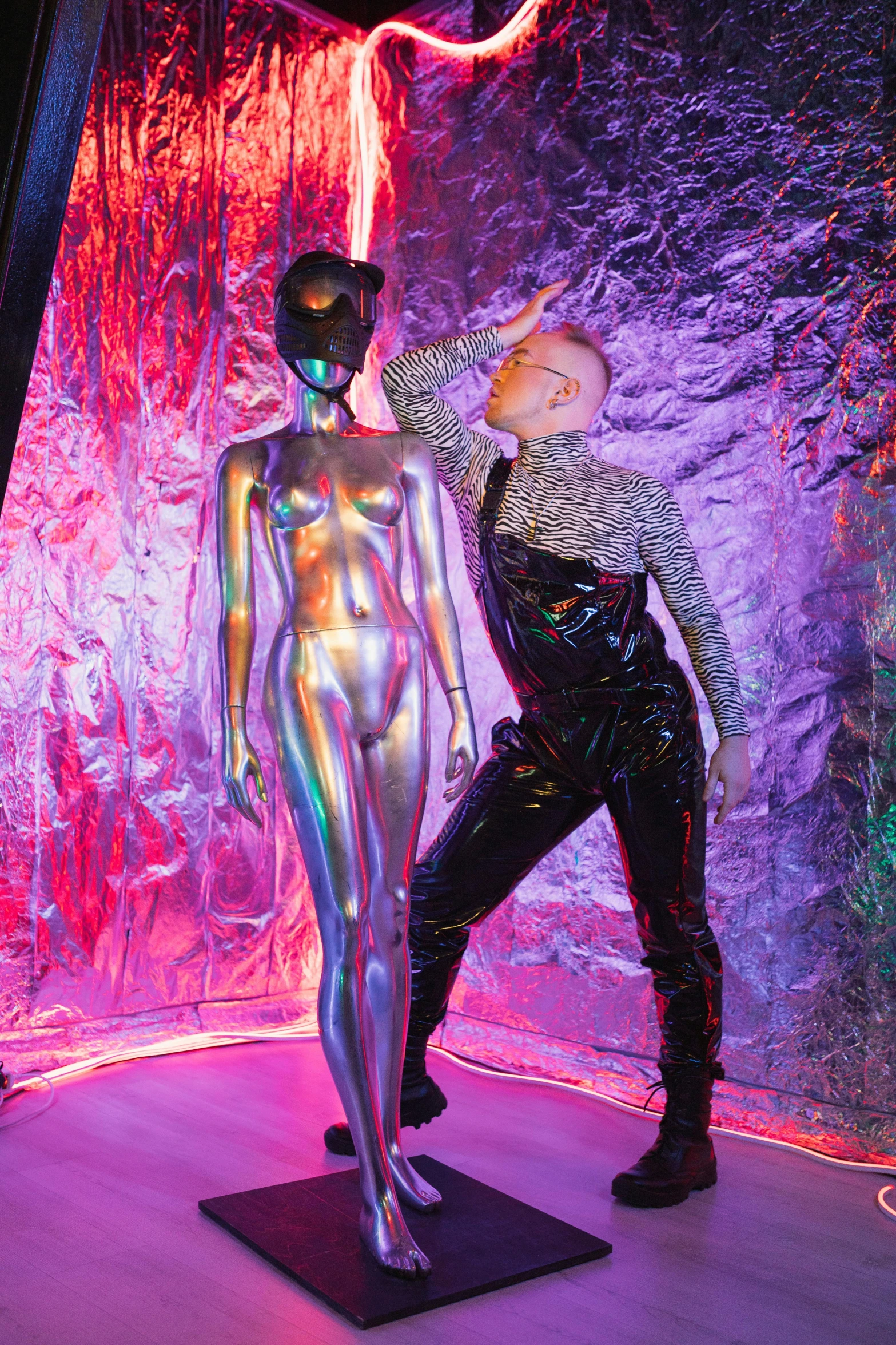 a man that is standing next to a mannequin, inspired by David LaChapelle, holography, latex shiny, on a spaceship, silver skin, gustav klimt and mel ramos