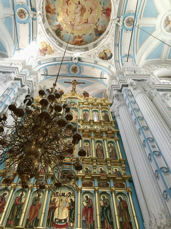 a chandelier hanging from the ceiling of a church, inspired by Illarion Pryanishnikov, baroque, light grey blue and golden, ilya golitsyn, february)