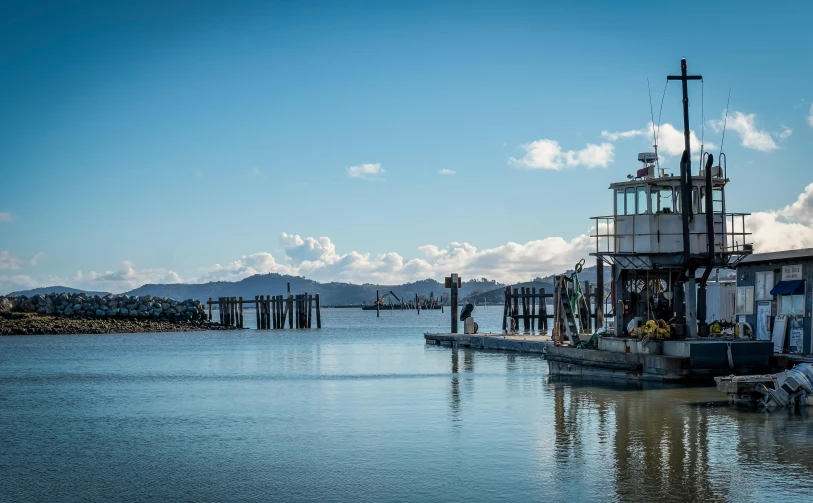 a large boat sitting on top of a body of water, a portrait, by Susy Pilgrim Waters, unsplash, hurufiyya, vallejo, wood pier and houses, te pae, slide show