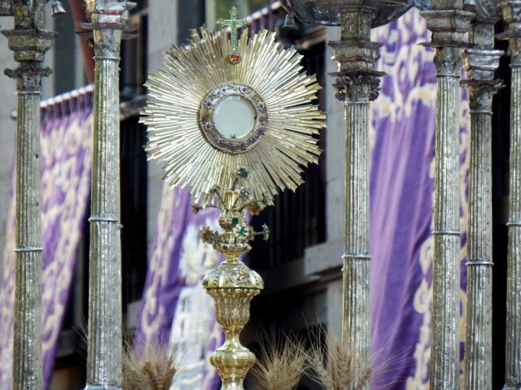 a close up of a statue of a person with a cross, inspired by Francisco de Burgos Mantilla, pexels, purple sun, overturned ornate chalice, fully decorated, intricate ornament halo