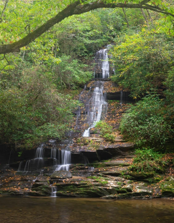 a waterfall in the middle of a forest, water running down the walls, appalachian mountains, slide show, voge photo