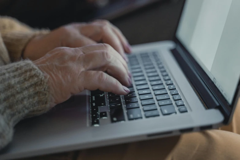 a close up of a person typing on a laptop, by Carey Morris, an elderly, lynn skordal, high quality upload, bottom angle