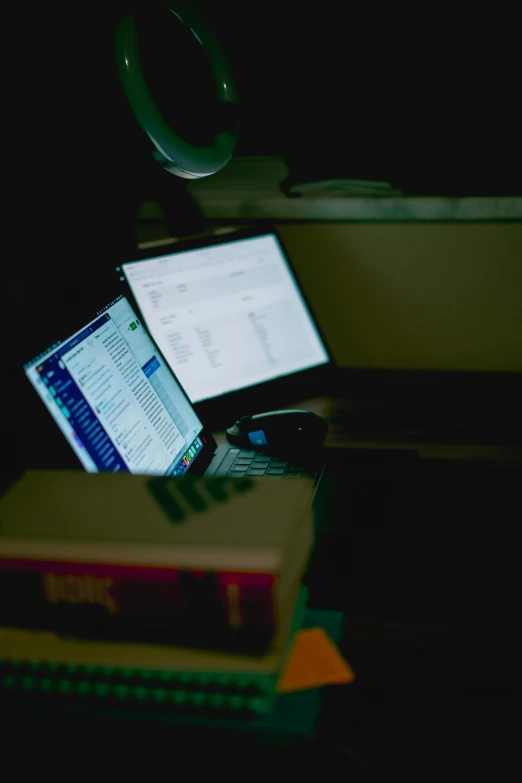 a laptop computer sitting on top of a desk, inspired by Elsa Bleda, captured in low light, book library studying, difraction from back light, imgur