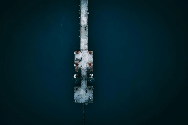 a knife sitting on top of a piece of metal, by Tobias Stimmer, unsplash contest winner, minimalism, frozen sea, bridge, satellite view, dark blue