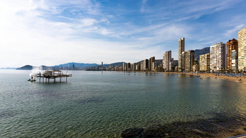 a large body of water surrounded by tall buildings, pexels contest winner, costa blanca, shoreline, thumbnail, high resolution