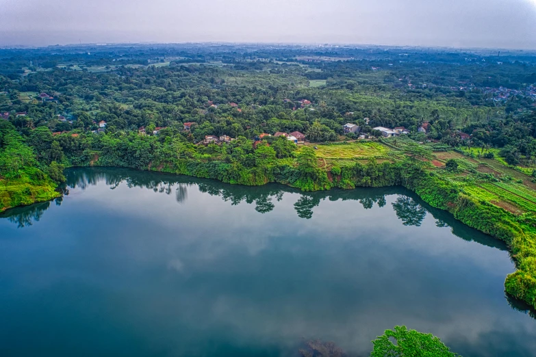 a large body of water surrounded by trees, a tilt shift photo, hurufiyya, guwahati, fan favorite, hd aerial photography, panoramic