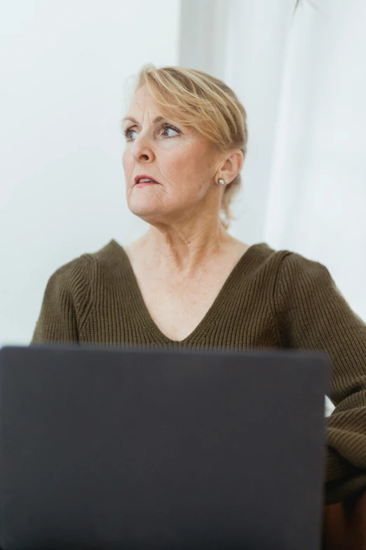 a woman sitting in front of a laptop computer, trending on reddit, aging, looking confused, professional profile photo, digital image