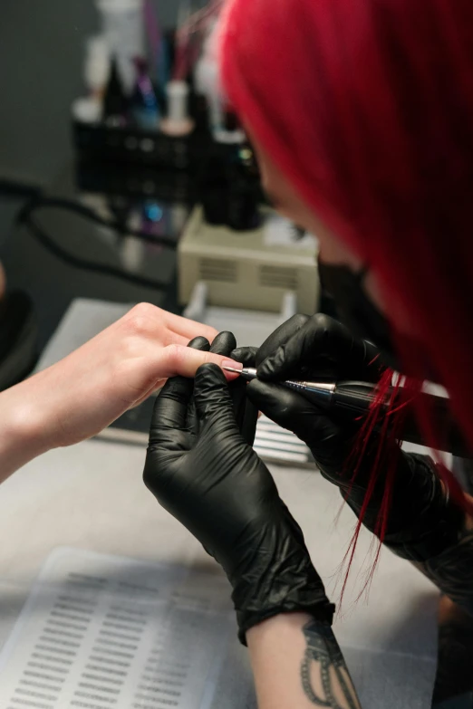 a woman getting her nails done at a salon, a tattoo, by Jason Felix, pexels, in a lab, thumbnail, 2506921471, female emo art student